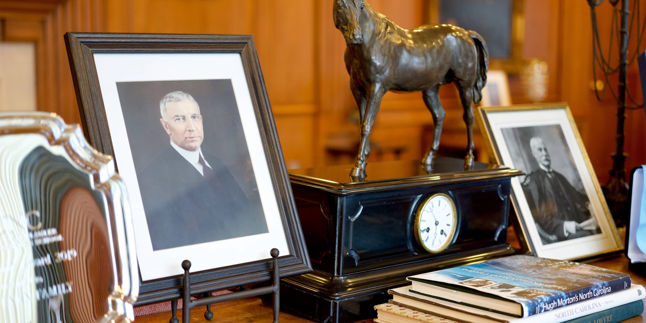 A picture frame featuring William R. Kenan Jr. on a desk