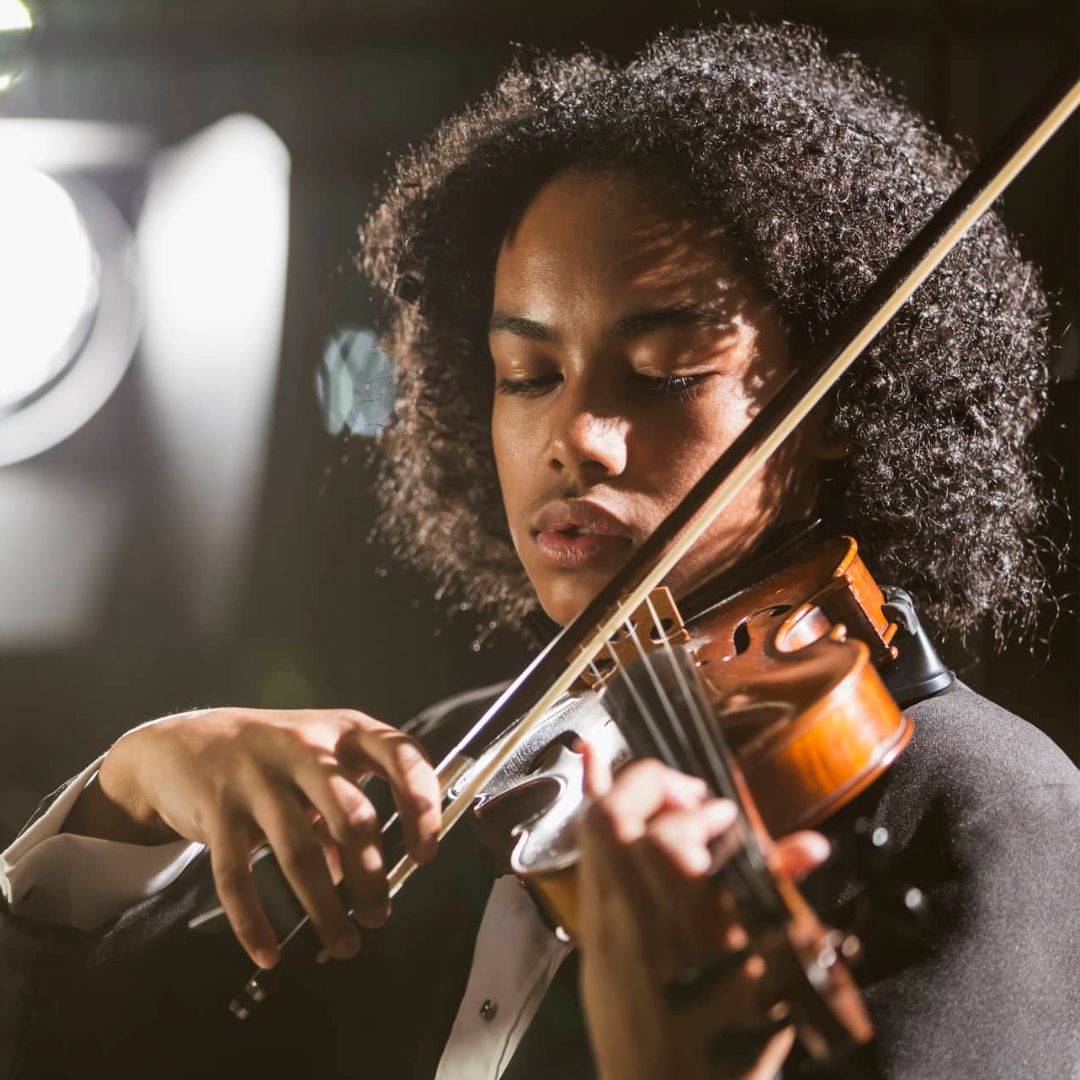 A mixed-race teenage boy playing the violin