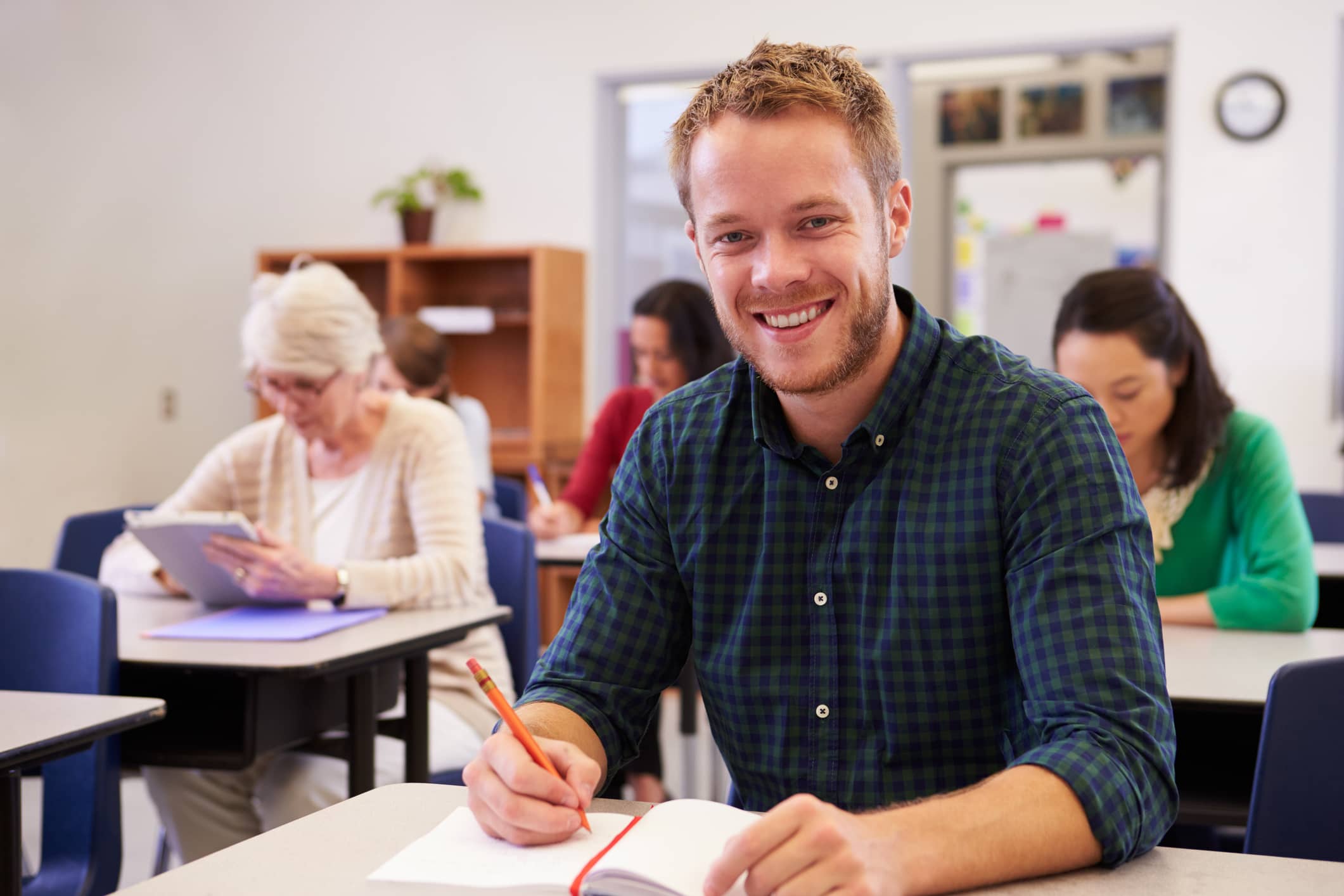 Young adult male in a classroom attending an adult education class